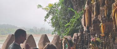 Family praying together at a temple