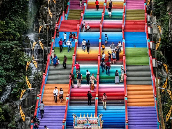 Tourists at the colourful steps of Batu Caves in Malaysia