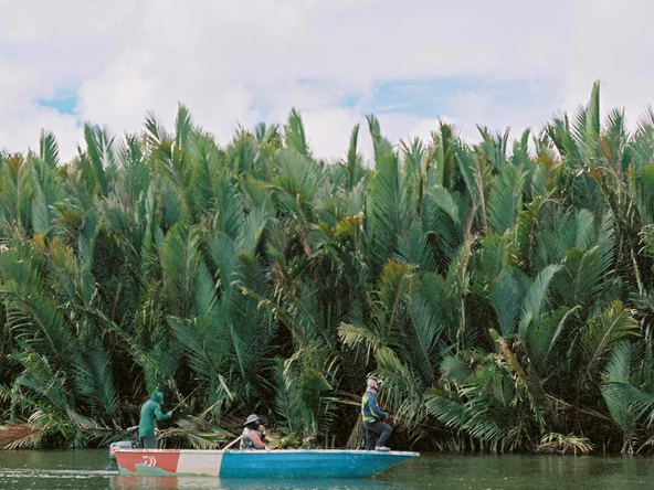A kayak floating past the jungle along Borneo's Kinabatangan River