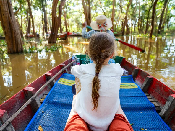 Cambodia family boat through mangroves