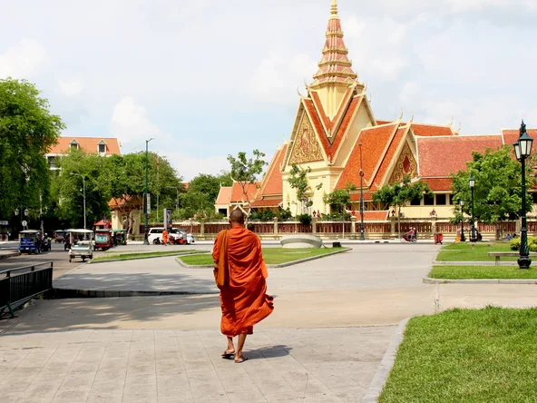 Monk walking towards the City Court House, although looks like a temple. Its next to the Royal Palace in Phnom Penh..