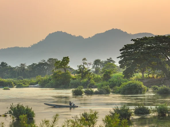 A boat going down the waterway in a quiet area of 4000 islands, Laos 