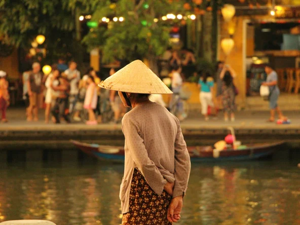 Local Vietnamese woman looking over the lantern lit river in Hoi An 