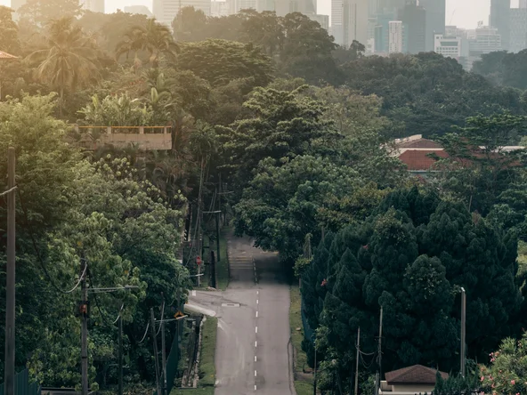 Man on a motorbike on a road in Kuala Lumpur Malaysia in front of the two towers