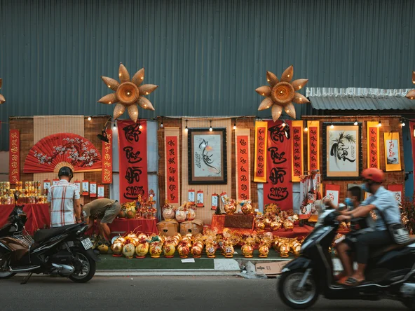 Locals on motorbikes whizzing past a store in Ho Chi Minh city during Tet celebrations