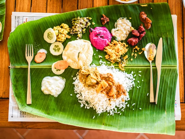 Banana leaf with bright curries, curds and chutneys