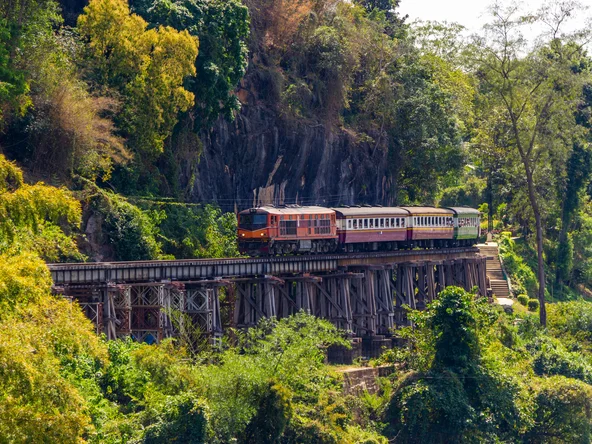A train hugging the edge of a cliff in Kanchanaburi