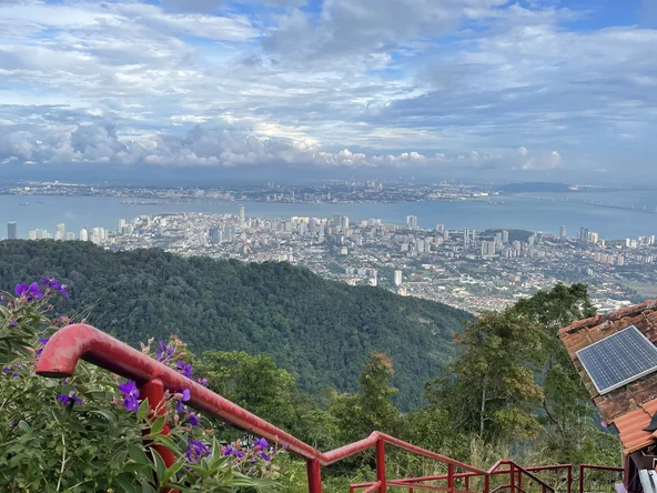 Colourful steps in the foreground, with an elevated view over a cityscape in the background