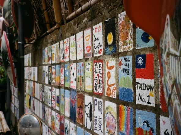 Individual postcard-sized paintings on a wall