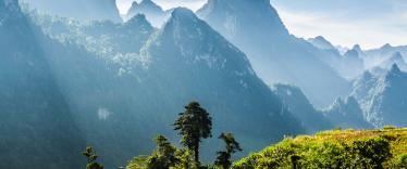 Mountain and blue sky at Kasi, Laos. and little home in grass field in front of mountain