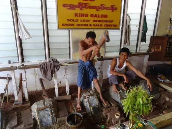Workers hammering out gold leaf in Mandalay