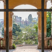 An old brick archway partially painted provides beautiful views of royal palance in Phnom Penh