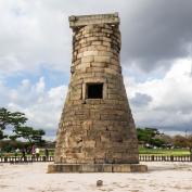 Large stone monument in middle of fenced off area