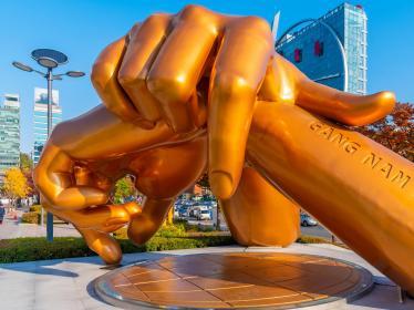 Sculpture of golden hands resting on each other as a Gangnam Style monument in Seoul