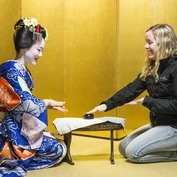 Playing drinking games with a maiko in a yellow room in Kyoto 