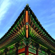 Pointed edge of ornate temple rooftop 