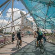 Cycling across modern bridge by Marina Bay, Singapore