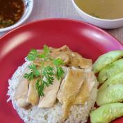 Hainanese chicken and rice with cucumber garnish