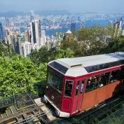 Red tram climbing up hillside to Victoria Peak in Hong Kong