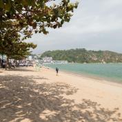 Person walking along Tung Wan beach