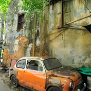Orange vintage car street art on wall in Talad Noi, Bangkok 