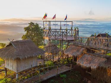 Viewing platform at Golden Triangle with flags showing directions to Laos and Myanmar