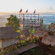 Viewing platform at Golden Triangle with flags showing directions to Laos and Myanmar