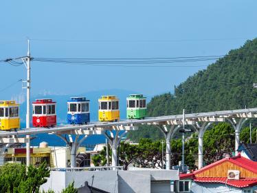 Cute and colorful little trams are lined up in Haundae's Blue Park in Busan, South Korea