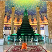 Monk praying inside temple in Bangkok