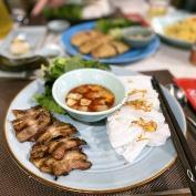 Vietnamese dishes laid out on plate with chopsticks and dipping sauce