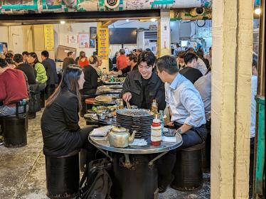 Three friends enjoying Korean street food