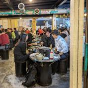 Three friends enjoying Korean street food