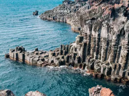Top-down view over cliffs of Jeju Island above the sea in South Korea
