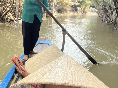 Female tourist with local on Mekong Delta river tour