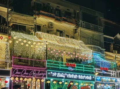 Shop fronts on train street in Hanoi lit with fairy lights