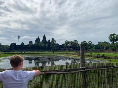 A young boy looking at Angkor Wat temple on a family trip to Cambodia