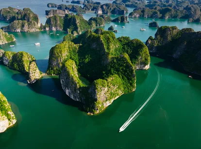 An aerial view of Lan Ha Bay limestone karsts and a cruise ship in November