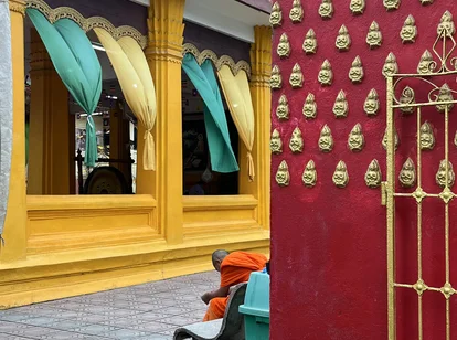A monk praying in Vientiane temple in Laos