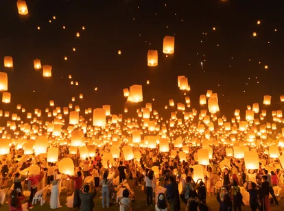 Thai people release sky floating lanterns or lamp to worship Buddha's relics at night. Traditional festival in Chiang mai, Thailand. Loy krathong and Yi Peng Lanna ceremony.