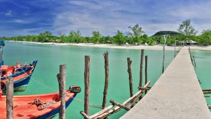 A wooden pier over turquoise water in Koh Rong