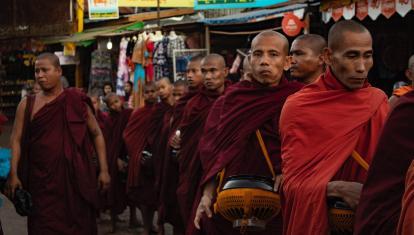 Monks walking through a market in Myanmar