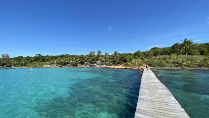 A boardwalk over clear blue waters in Ko Kood, Trat Islands, Thailand