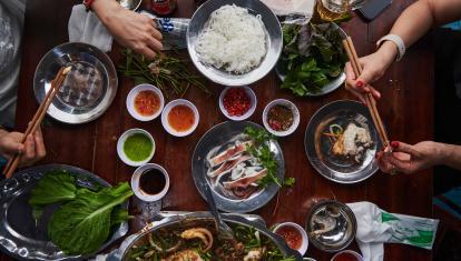 Local Vietnamese women sharing traditional food in Vietnam