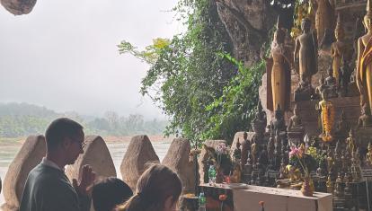 Family praying together at a temple