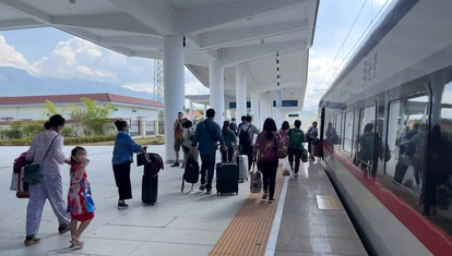 People at a train station in Laos
