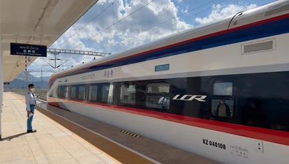 Train in train station with clouds