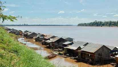 A floating Vietnamese village is anchored to the island by cables.