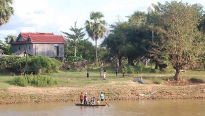 These boys cross the river for a game of footy with their mates on the other side.