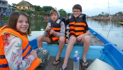 Kids on a boat in Hoi An, Vietnam