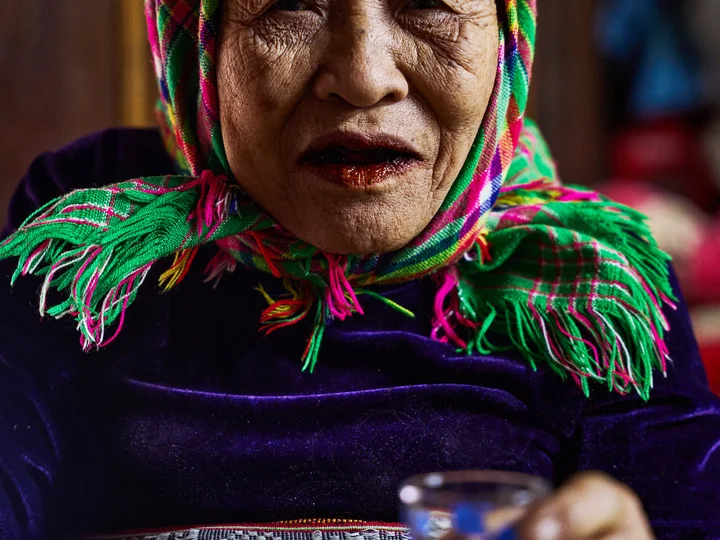 Vietnamese lady offering shot glass